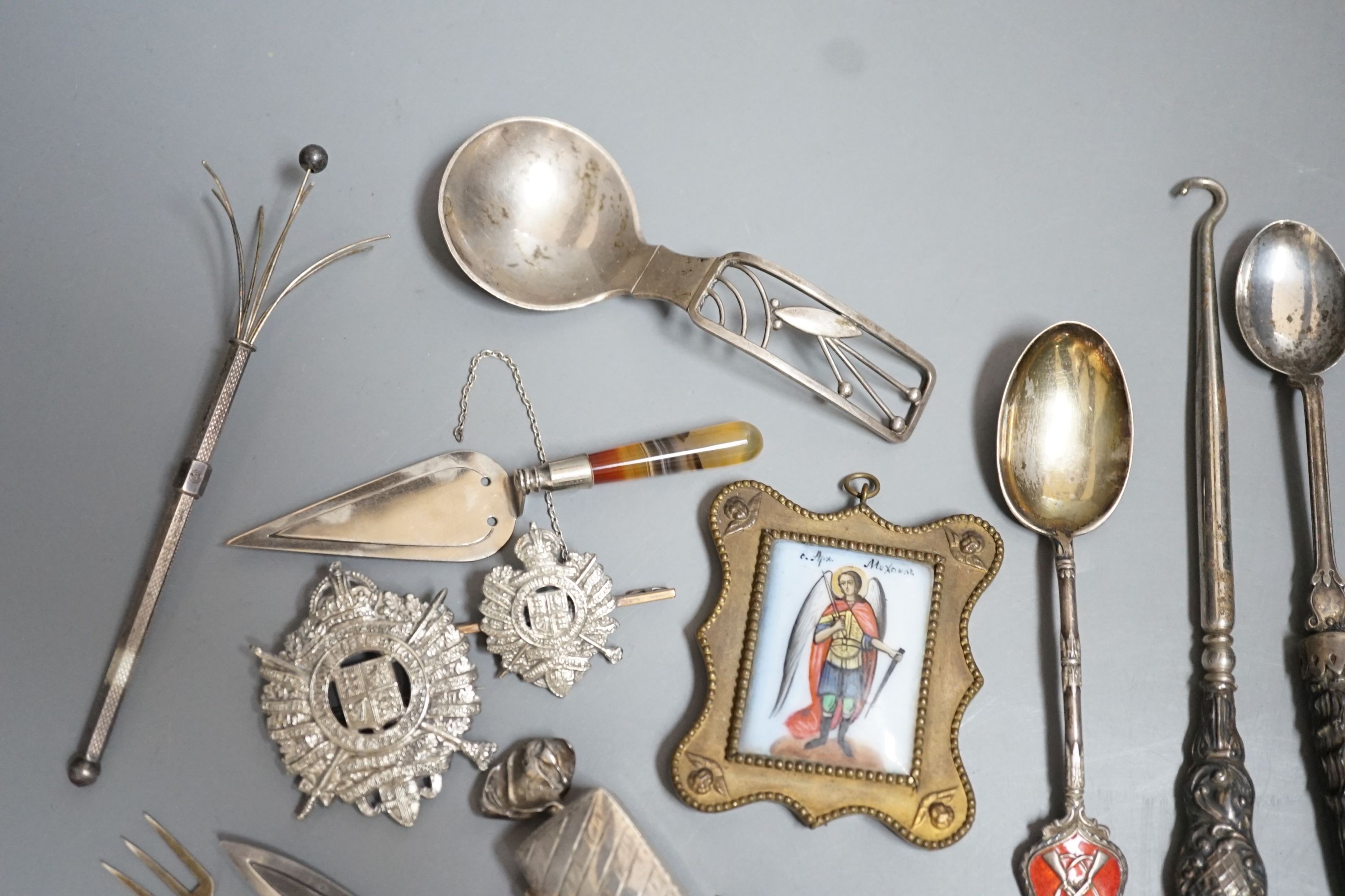 Sundry small silver etc. including a Danish sterling caddy spoon, by Franz Hingelberg, 9.7cm, nephrite handles silver gilt paper knife, swizzle stick, button hook, agate handled trowel bookmark, two badges etc.